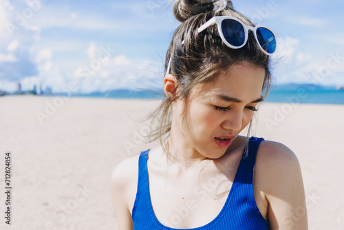 Asian woman fear bright sun at the beach in Pattaya, Thailand. Skincare concept.