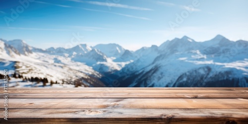 Snow-capped Alpine background and an exuberant image of an empty wooden table top.