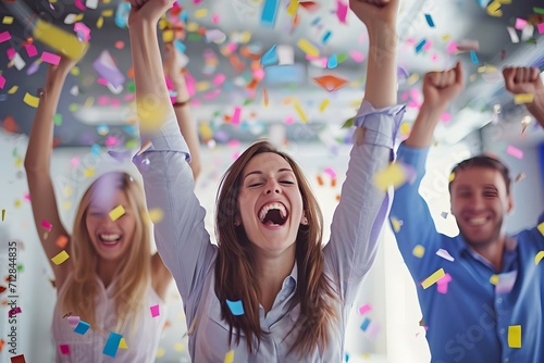 A business team with raised fists celebrating a milestone, highlighting workplace enthusiasm and achievement