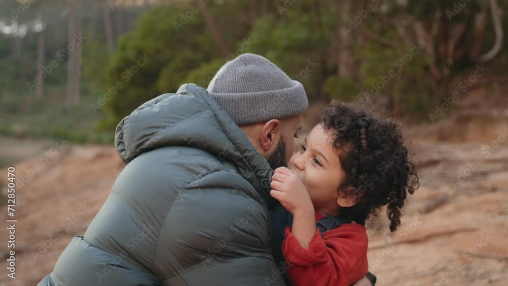 Father-son bonding in a forest setting. The little boy embraces his dad, sharing a secret. A tender moment of family love and trust outdoors. Father-son bonding in a forest setting. The little boy embraces his dad, sharing a secret. A tender moment of family love and trust outdoors.