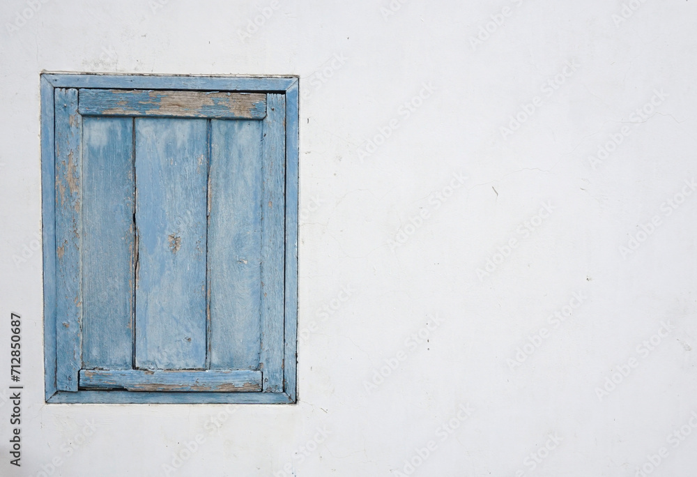 blue painted window in the old wall.