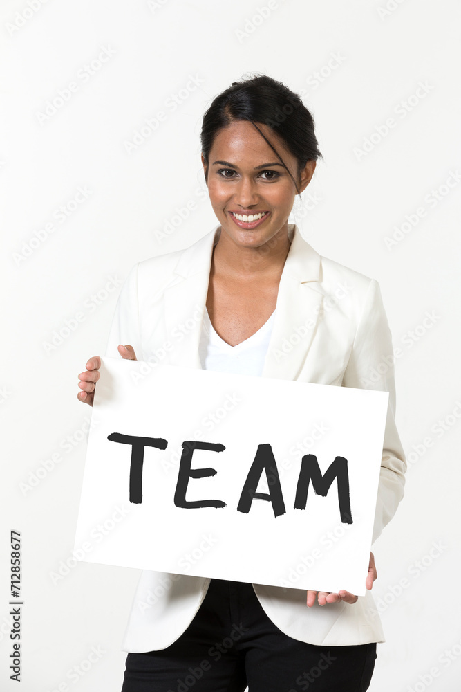Indian businesswoman holding a white banner with word 'Team'. Indian businesswoman holding a white banner with word 'Team'.