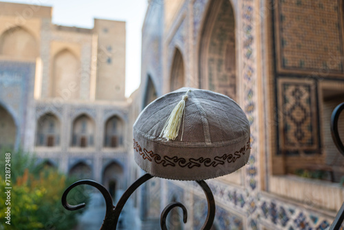 Photos Folk art of Uzbekistan, skullcap handmade against background of a beautiful madr