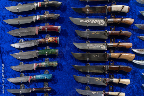 knives made of Damascus steel on counter in the store. photo