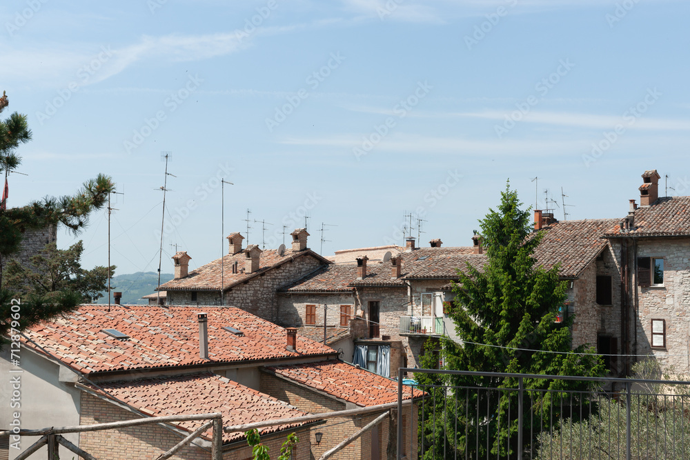 Rooftops and landscape of old Italian walled city on mountainside