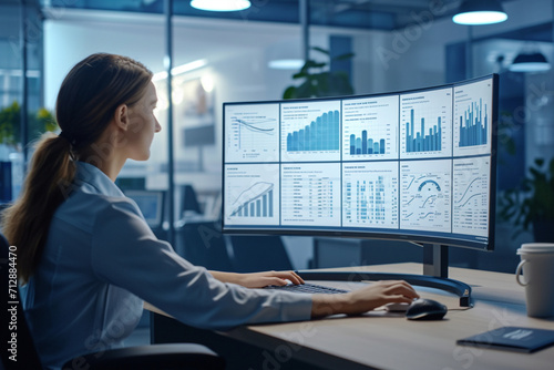 Professional Analyzing Financial Data on Multiple Screens
