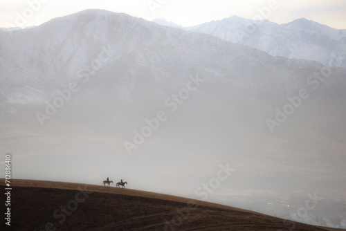Obraz na plátně Two riders in view of Tian Sian mountains