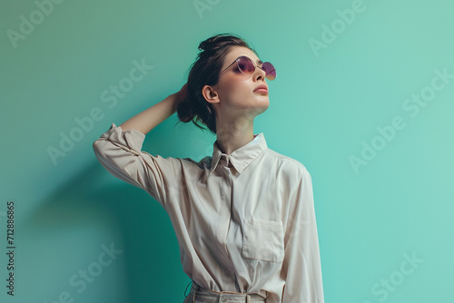 portrait of a fashion young woman in a studio muted color background and minimalistic © Madhulatha