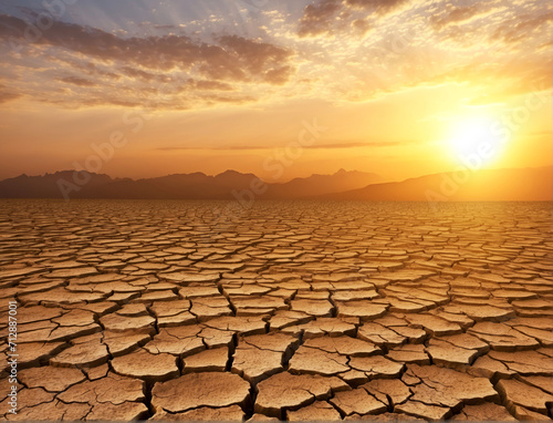 Arid Clay soil Sun desert global worming concept cracked scorched earth soil drought desert landscape dramatic sunset