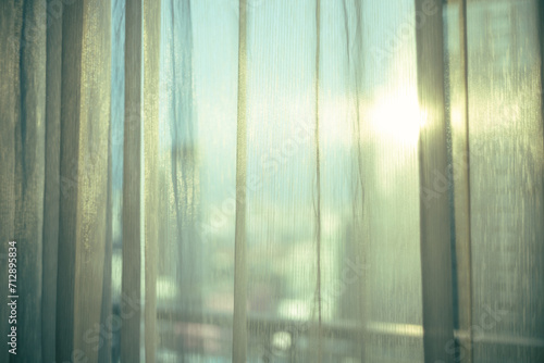 sheer curtain (translucent fabric) and balcony from high rise condominium with sunlight reflection, lonely feeling after staying home all day or all week, shallow depth of field