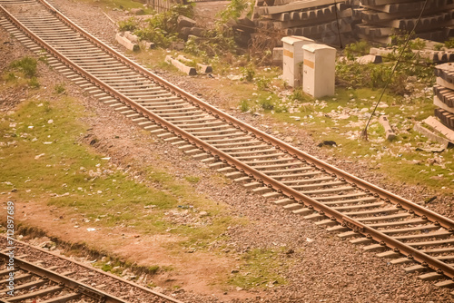 View of train Railway Tracks from the middle during daytime at Kathgodam railway station in India, Toy train track view, Indian Railway junction, Heavy industry photo