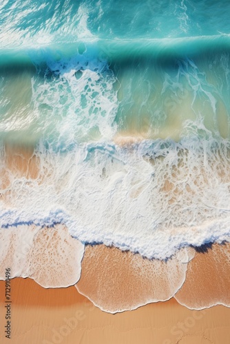 Aerial shot of a tropical beach with waves crashing on sandy shore