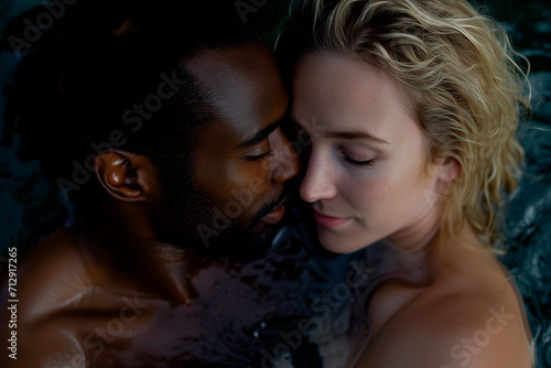 Young interracial couple in love in hot tub, spa wellness photo
