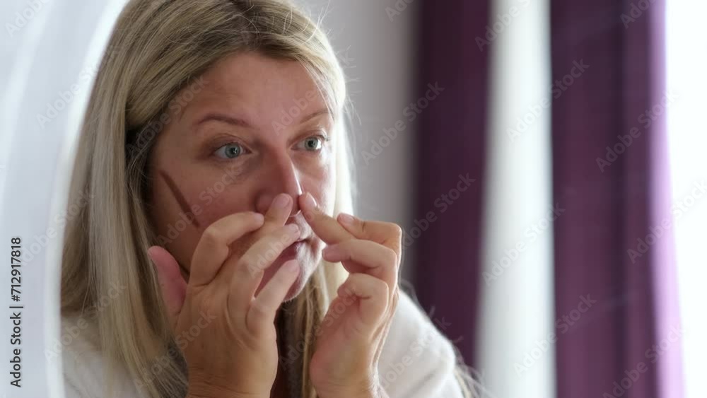 Woman blends a contour highlight lines of her face. Face sculpting with makeup Woman blends a contour highlight lines of her face. Face sculpting with makeup