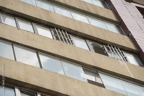 A broken window in a high-rise apartment building.