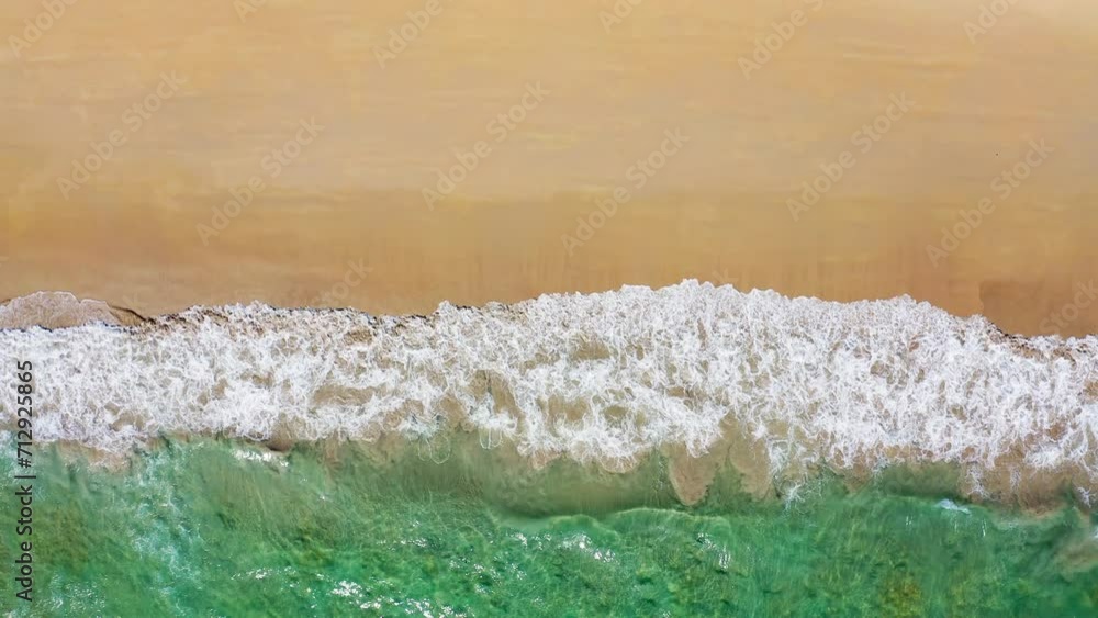 Beach aerial view, with emerald green ocean waves breaking on the sand. Beach aerial view, with emerald green ocean waves breaking on the sand.