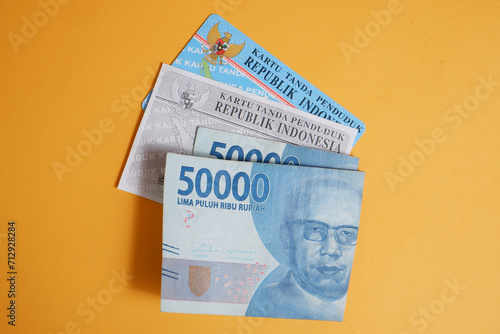 a photocopy of his KTP and a 50,000 rupiah note. concept illustration of buying or bribing election votes	
 photo