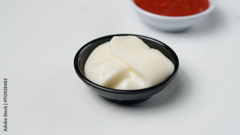 three sauces ketchup mayonnaise, sweet soy sauce and chili sauce in black bowl isolated on white background three sauces ketchup mayonnaise, sweet soy sauce and chili sauce in black bowl isolated on white background