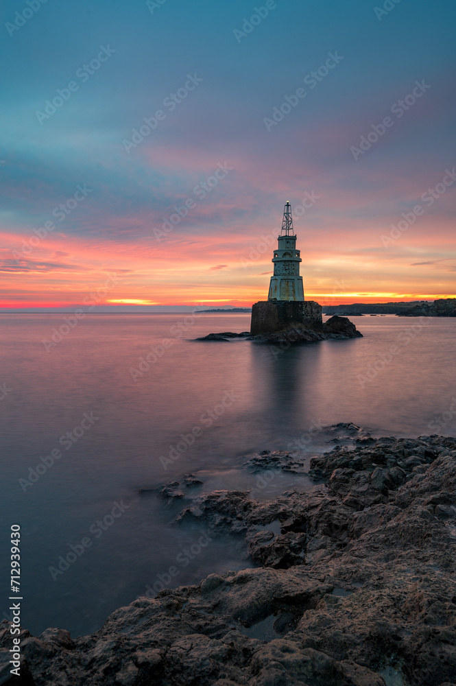 Solitude Radiance: Lone Lighthouse at Sunrise