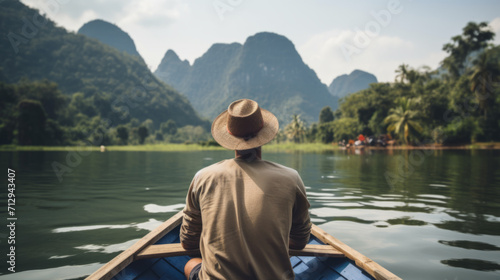 Rear view of man paddling the wooden boat © Natalia Klenova
