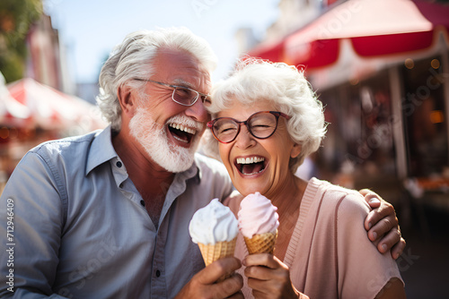 Cheerful senior couple eating icecream cone. Joyful elderly lifestyle concept. Two senior people white haired
