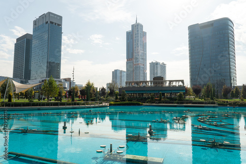 Awesome view of contemporary buildings reflected in pool of Tashkent City Park in Tashkent, Uzbekistan. The park is a popular recreational gathering place among residents and tourists.