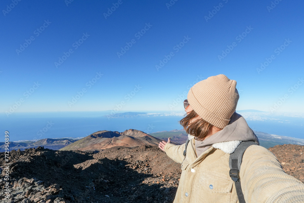 Man Standing on Mountain, Pointing at Sky