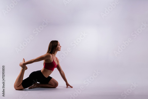 Beautiful woman doing Lotus of Padmasana or Kamalasana pose on yoga class. Studio shot. photo