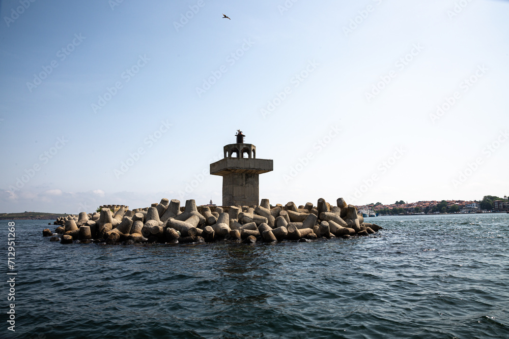 Fotografie Old comcrete lighthouse in the sea