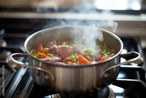 beef stew simmering on stove, pot lid askew