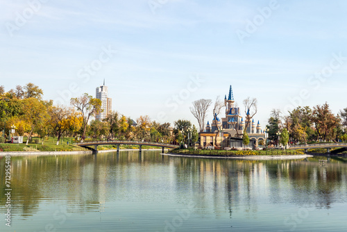 Tower building, tulips, singing fountain in Amusement Park Magic City former Komsomolskoye lake