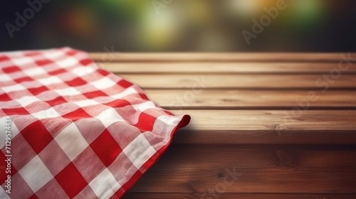 Close-up Checkered red and white tablecloth on wooden table. photo