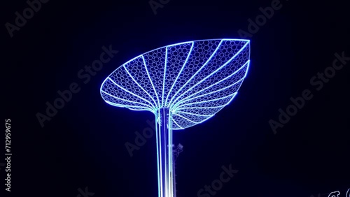 Large illuminated figure of nenuphar water lily leaf at night, decorations for the New Year and Christmas Eve. City lighting in Soho Square, Sharm El Sheikh. Tourism travel in Egypt