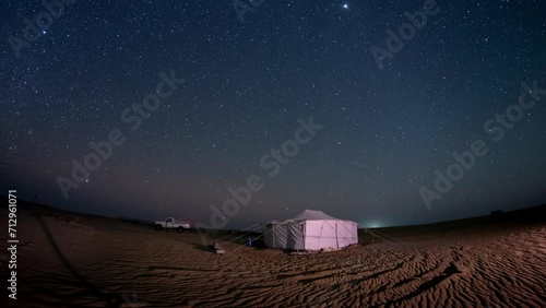 Time lapse of night Stars motion with Gemini Meteors shooting in safari desert camping camel farm Bedouin photo
