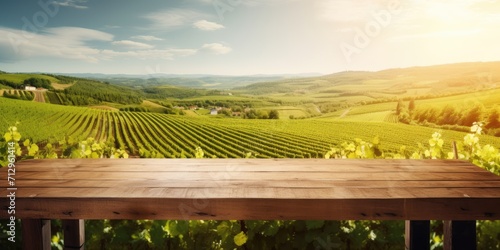 Energetic picture of a vineyard  with a clear wooden table.