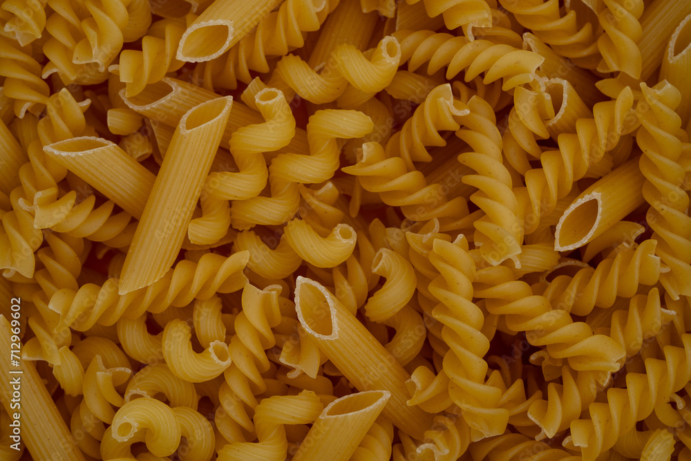 Texture of Uncooked Penne and Fusilli Pasta Mix Texture of Uncooked Penne and Fusilli Pasta Mix