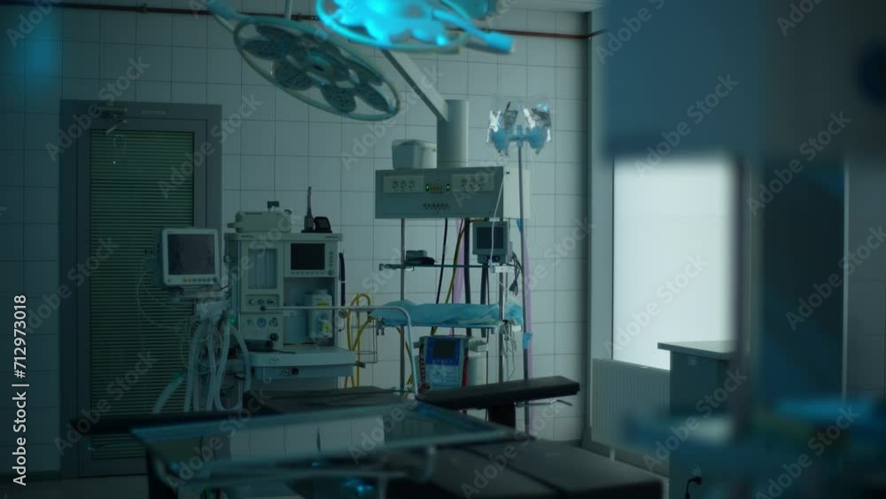 Interior of dark hospital room for operation, emergency service and healing patient. Healthcare backgrounds, surgery theatre and interior of bed, machine and medical tools for wellness, slow motion. Interior of dark hospital room for operation, emergency service and healing patient. Healthcare backgrounds, surgery theatre and interior of bed, machine and medical tools for wellness, slow motion.