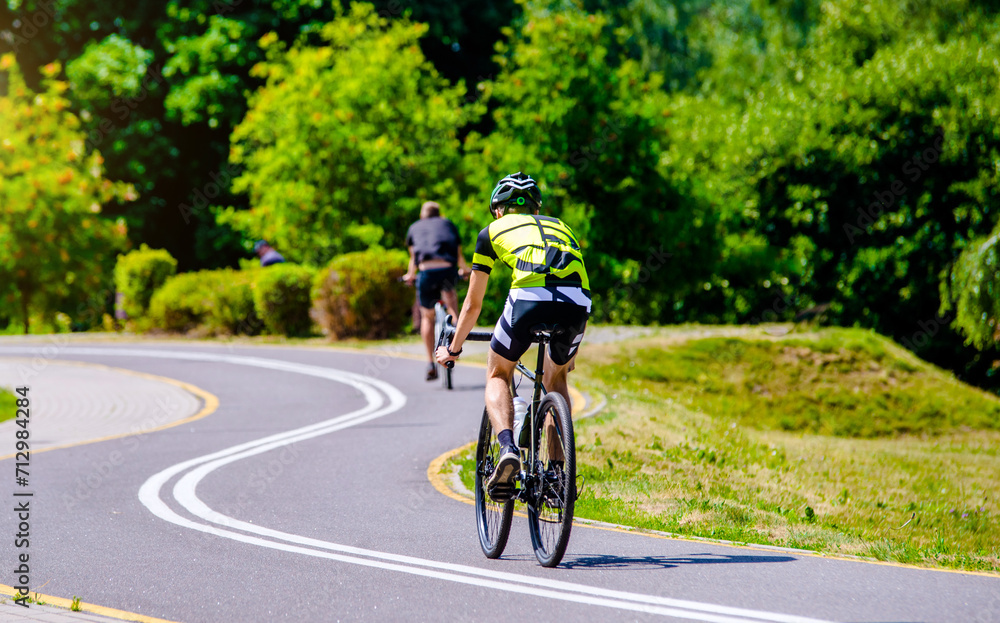 Fototapeta premium Cyclist ride on the bike path in the city Park