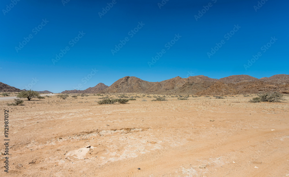 gravel road and Naukluftberge mountain range, near Sesriem,  Namibia