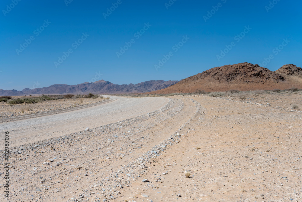 bending gravel road and Naukluftberge mountain range, near Sesriem,  Namibia