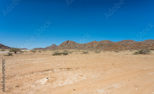 gravel road and Naukluftberge mountain range, near Sesriem, Namibia