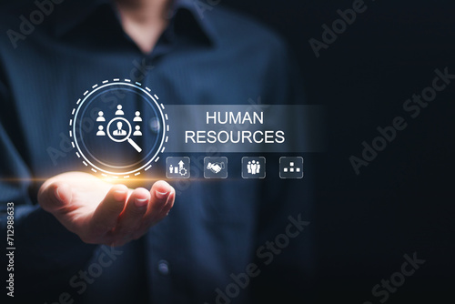Businessman hold virtual HR word with human resources icon for recruitment process to work efficiently and achieve sustainable business success. team building. Human Resources HR management concept. photo