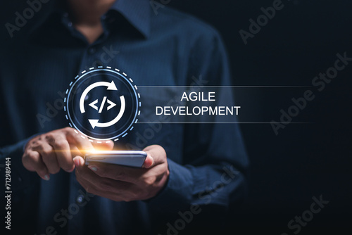Agile development methodology, businessman use smartphone with virtual screen of agile icon for process that will help you work faster By reducing step-by-step work and focusing on team communication. photo