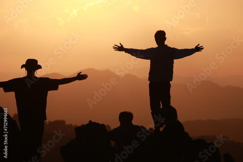 silhouette of two people on sunset background