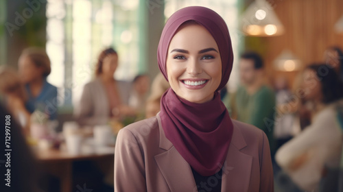 Happy woman wearing a hijab with a pleasant smile attending a social gathering. © red_orange_stock