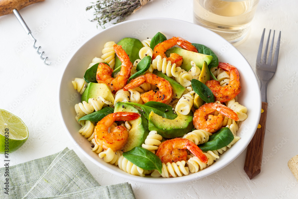 Pasta salad with shrimps, avocado and spinach. Healthy eating. Seafood.