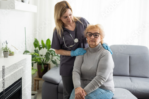 Happy patient is holding caregiver for a hand while spending time together.