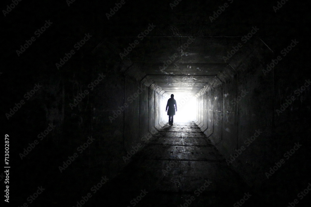 silhouette of a person in the tunnel