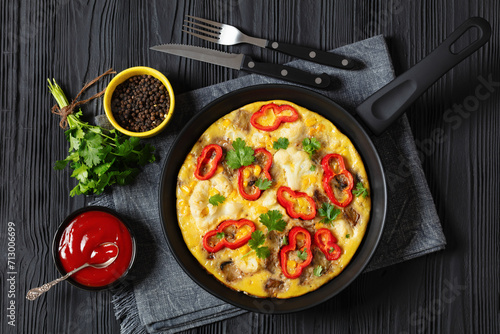 omelette with vegetables in a pan, top view