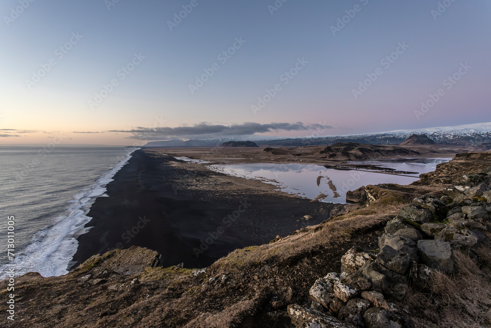 Lagoon behind The Endless Black Beach in Iceland in winter at sunset Lagoon behind The Endless Black Beach in Iceland in winter at sunset